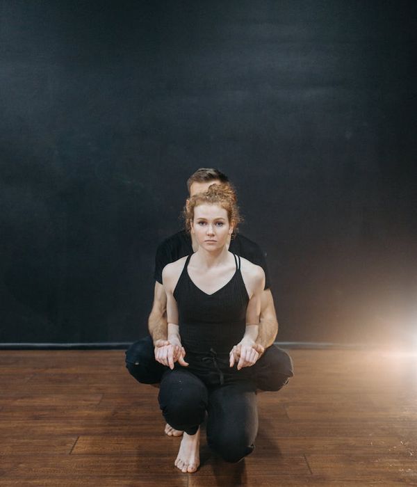 Woman performing a dynamic cardio movement with a focused expression.